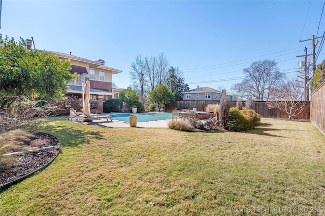 view of yard with a fenced in pool and a patio