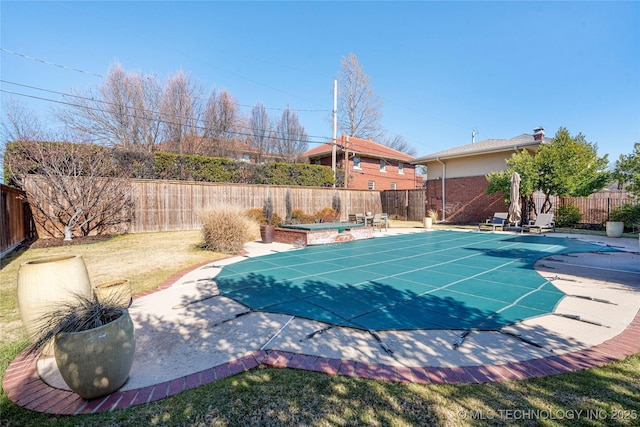 view of pool featuring a patio and a lawn