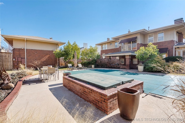 view of swimming pool with a patio