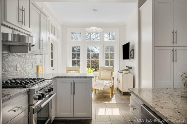 kitchen with light stone counters, ornamental molding, decorative light fixtures, and gas stove