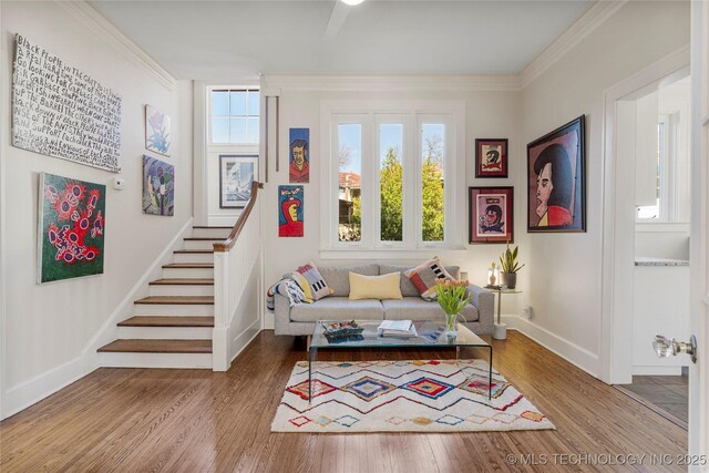 sitting room with hardwood / wood-style flooring and ornamental molding