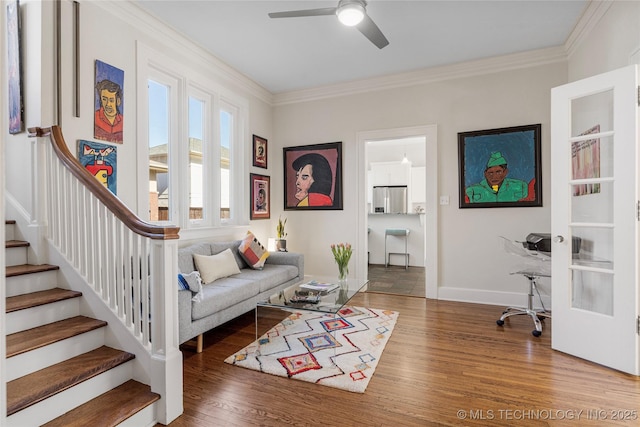 living room featuring hardwood / wood-style flooring, ceiling fan, and ornamental molding