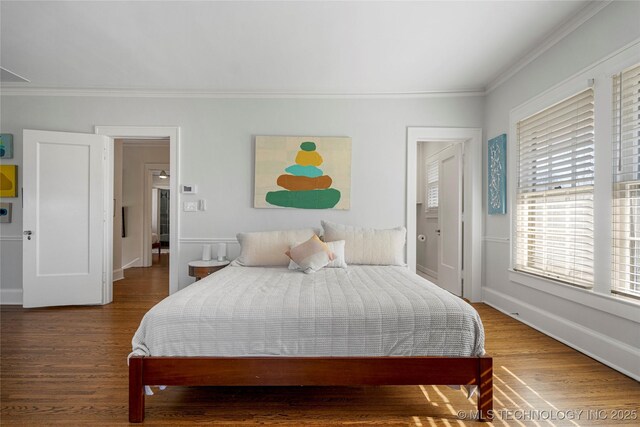 bedroom with crown molding and wood-type flooring