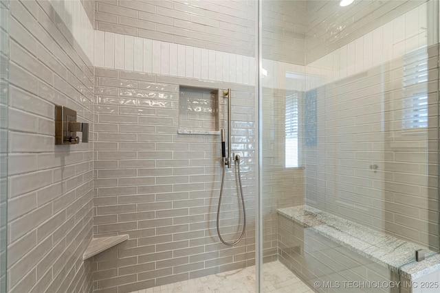 bathroom with a tile shower