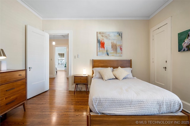 bedroom featuring wood-type flooring and ornamental molding