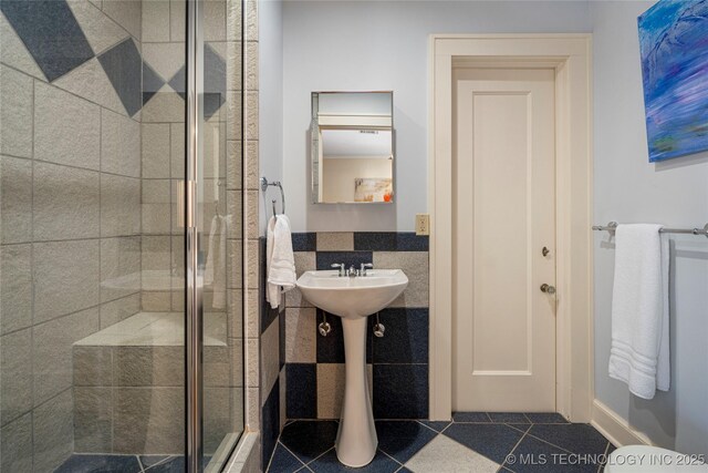 bathroom featuring an enclosed shower and tile patterned floors