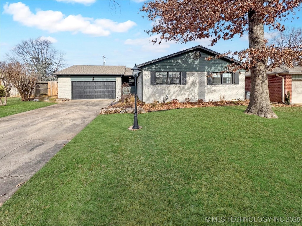 ranch-style home with a garage and a front lawn