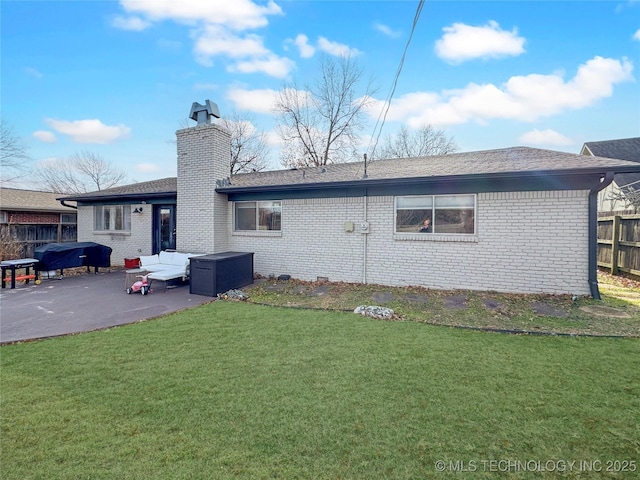 back of house featuring an outdoor hangout area, a patio, and a lawn