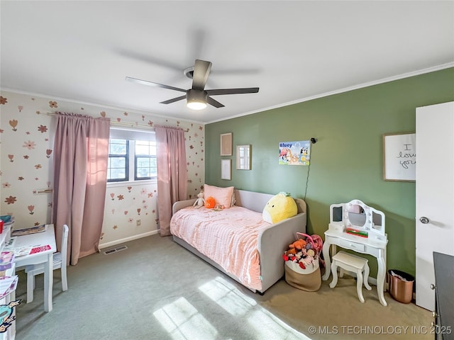 bedroom with ornamental molding, ceiling fan, and carpet flooring