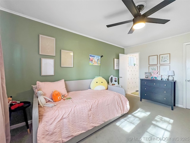 carpeted bedroom with ceiling fan and ornamental molding