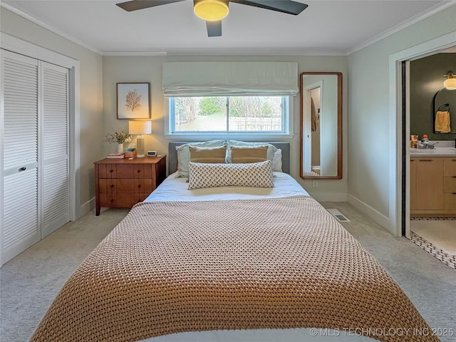 bedroom featuring crown molding, a closet, ceiling fan, and ensuite bathroom