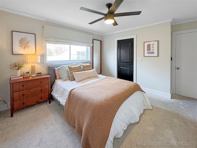 carpeted bedroom with ornamental molding and ceiling fan