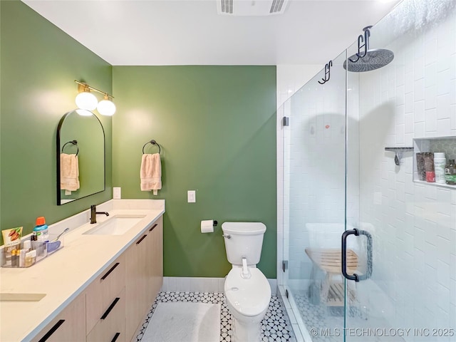 bathroom featuring tile patterned flooring, vanity, toilet, and walk in shower