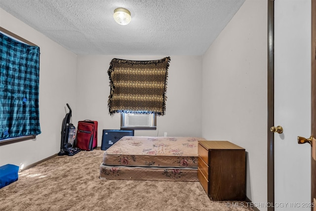 carpeted bedroom featuring cooling unit and a textured ceiling