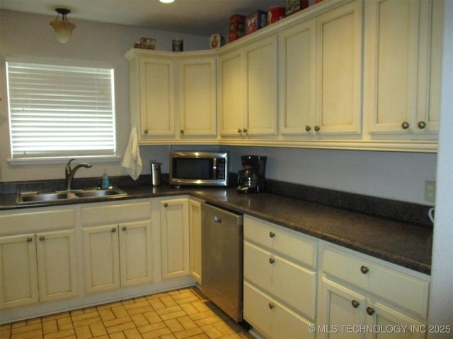 kitchen featuring sink, cream cabinetry, and appliances with stainless steel finishes