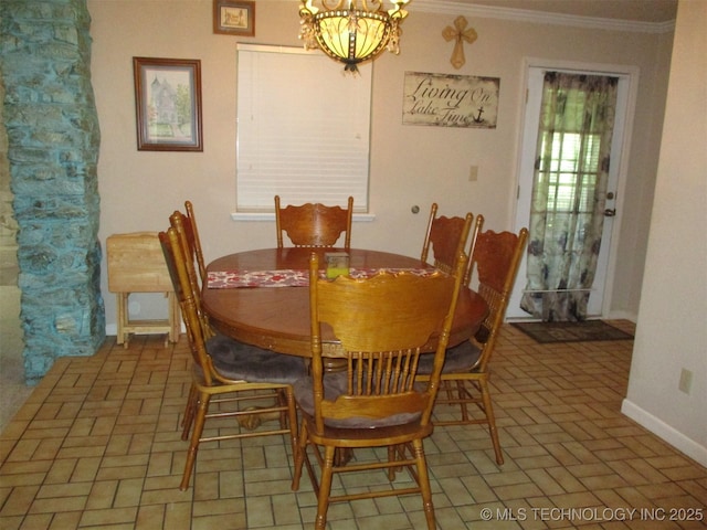 dining area with a notable chandelier and crown molding