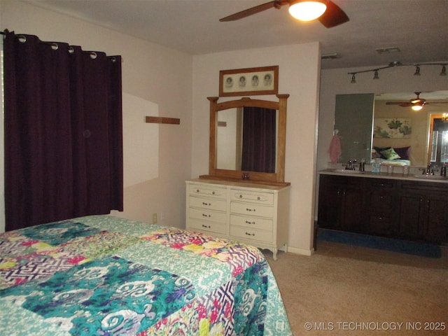 bedroom with sink, light colored carpet, and ceiling fan