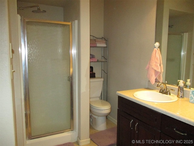 bathroom with vanity, toilet, and walk in shower