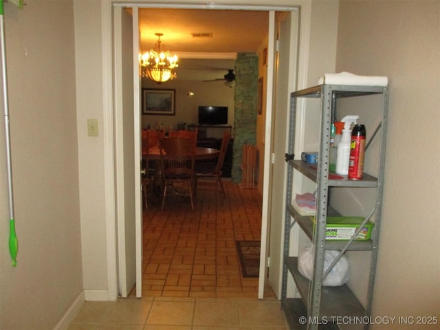 corridor featuring an inviting chandelier