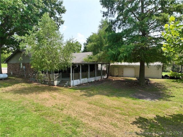 view of yard with a garage and a sunroom