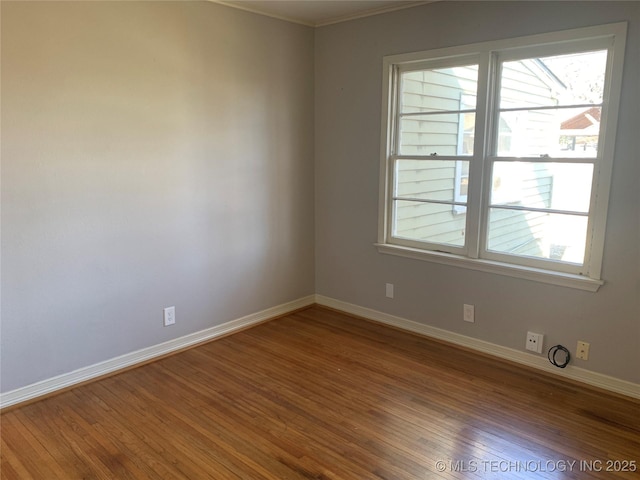 unfurnished room with hardwood / wood-style flooring