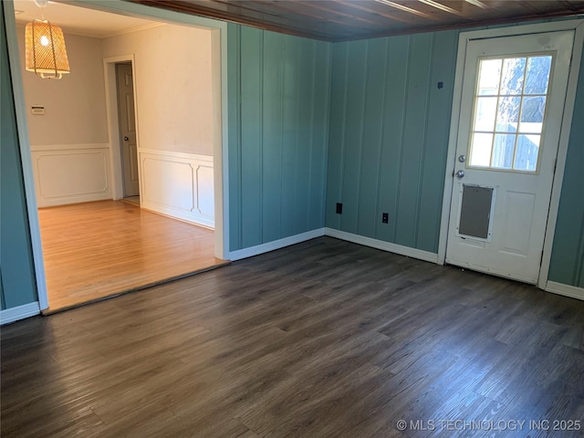 unfurnished room featuring ornamental molding and dark hardwood / wood-style flooring