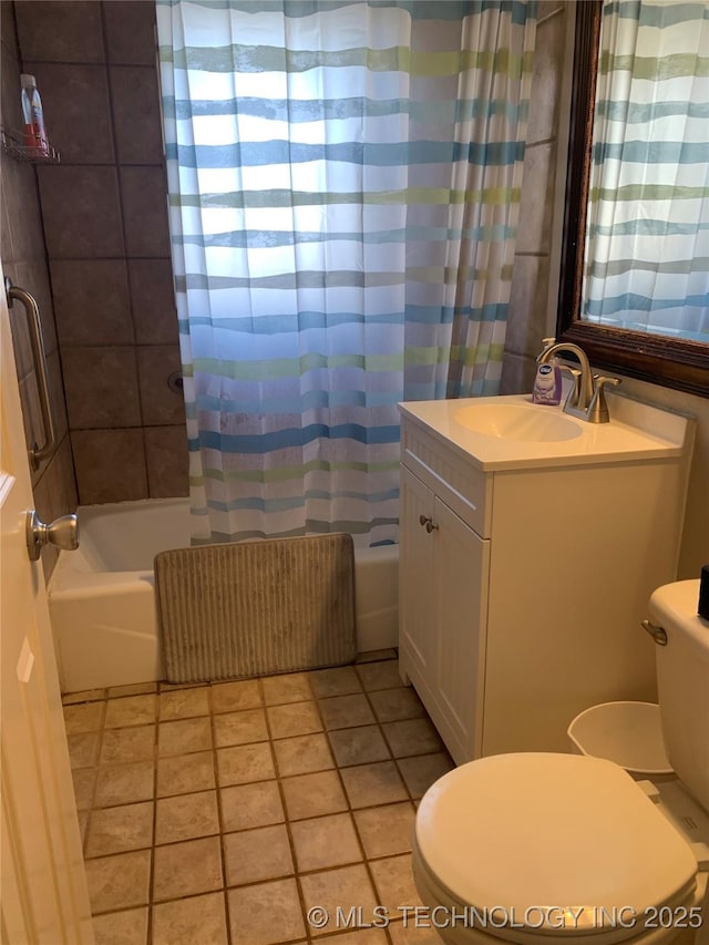 full bathroom with shower / tub combo with curtain, vanity, tile patterned floors, and toilet