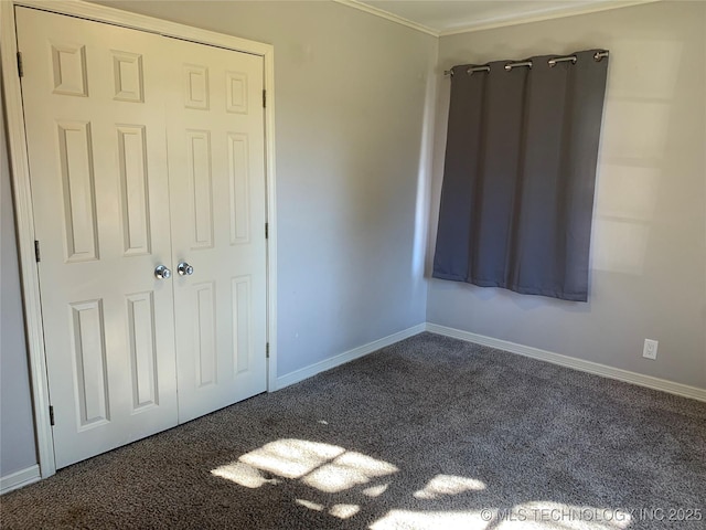 unfurnished bedroom featuring crown molding and dark carpet