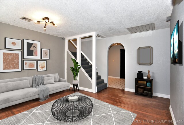 entrance foyer featuring dark hardwood / wood-style floors and a textured ceiling