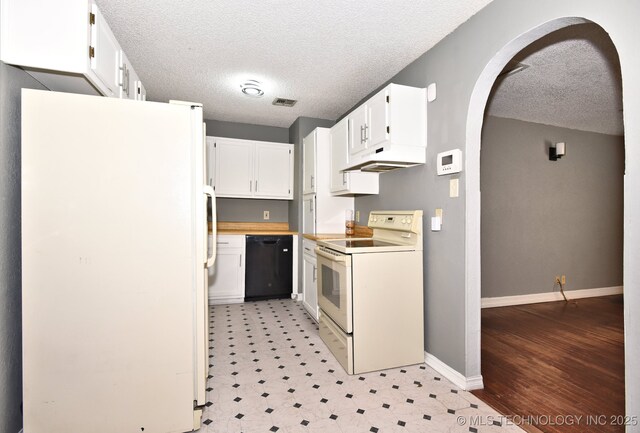 kitchen featuring white cabinetry, white appliances, and a textured ceiling