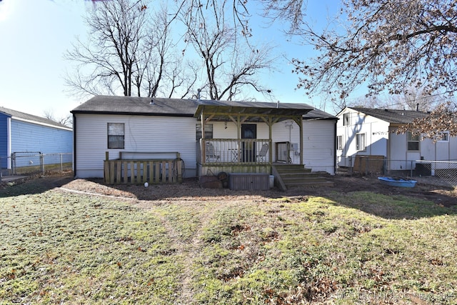 6273 E Marshall Pl, Tulsa, OK 74115 - rear view of property with a fenced backyard, a yard, and covered porch