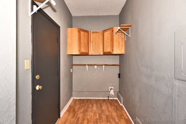 unfurnished bedroom featuring dark hardwood / wood-style flooring and a textured ceiling