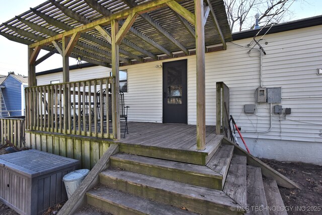 wooden terrace featuring a storage unit, a yard, and a pergola