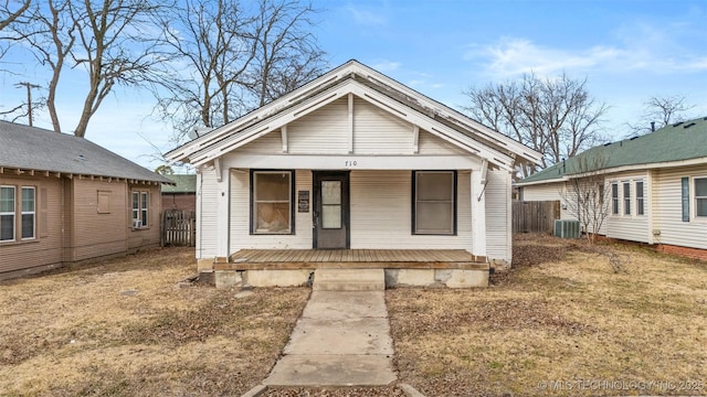 bungalow featuring central AC unit and a front yard