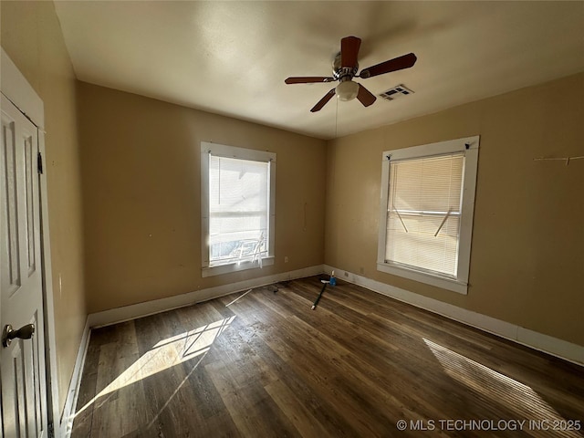 unfurnished room with ceiling fan and dark hardwood / wood-style flooring