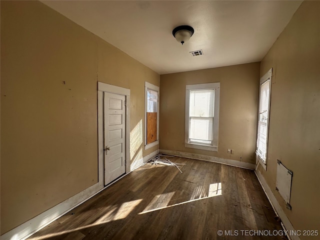 spare room with dark hardwood / wood-style flooring