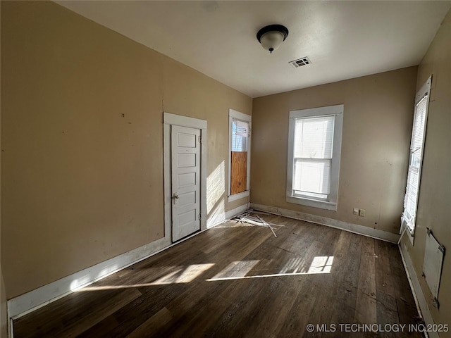 unfurnished room with dark hardwood / wood-style flooring