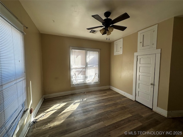 unfurnished bedroom featuring dark wood-type flooring and ceiling fan