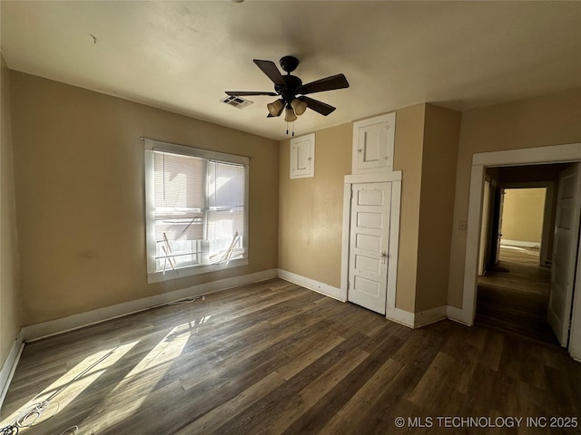 unfurnished bedroom with ceiling fan and dark hardwood / wood-style flooring