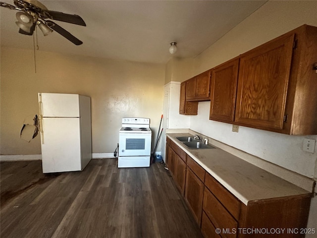 kitchen featuring dark hardwood / wood-style floors, ceiling fan, sink, and white appliances