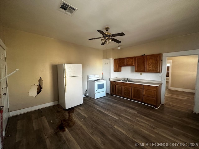 kitchen featuring ceiling fan, dark wood-type flooring, sink, and white appliances