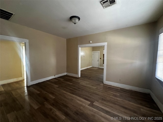 unfurnished room with dark hardwood / wood-style floors