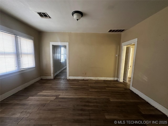 unfurnished room with dark hardwood / wood-style floors