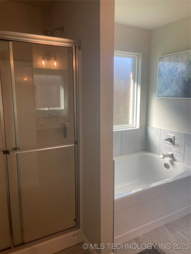 full bath featuring a stall shower and a bath