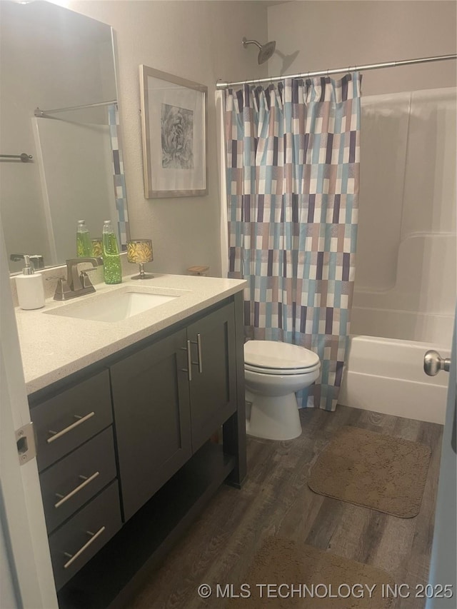 full bathroom featuring vanity, hardwood / wood-style floors, toilet, and shower / bath combo