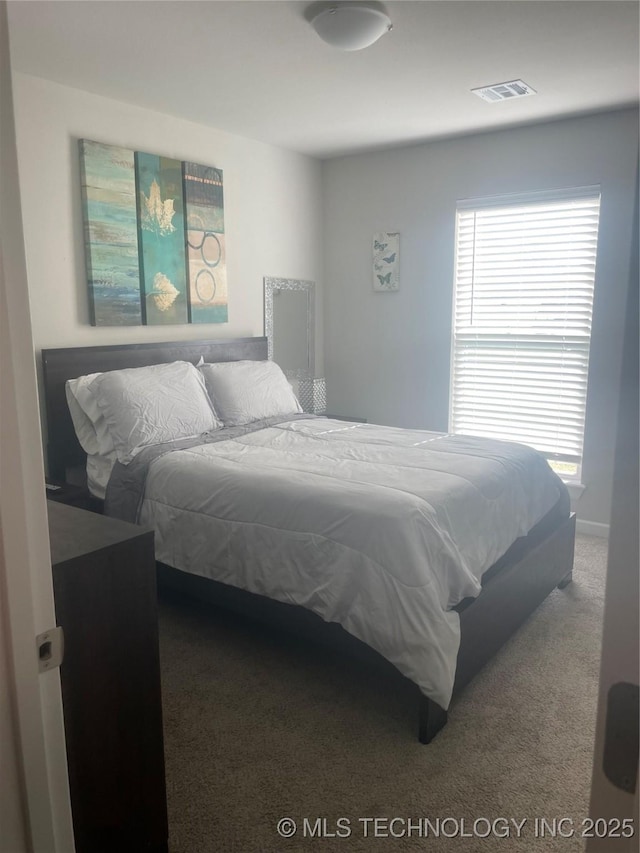 carpeted bedroom with visible vents