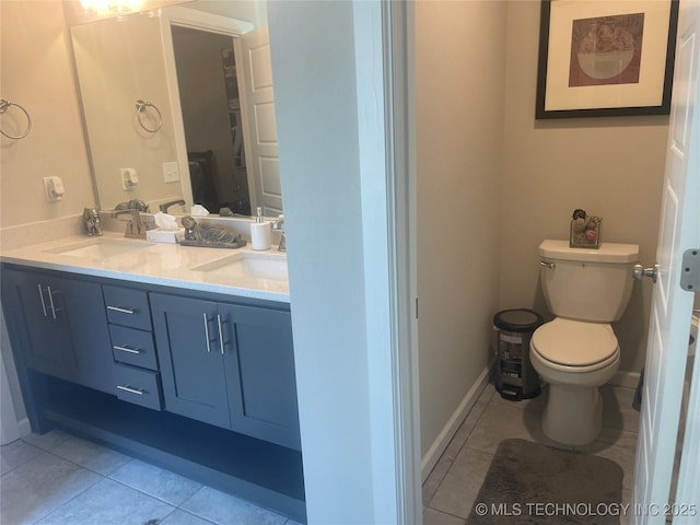 bathroom with tile patterned flooring, vanity, and toilet