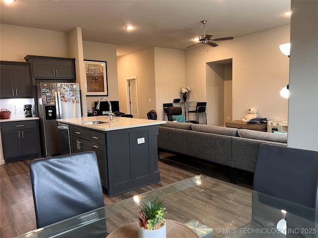 kitchen featuring dark wood-style floors, open floor plan, stainless steel appliances, and a sink