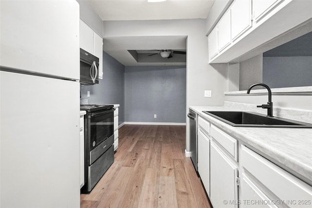 kitchen with sink, white cabinetry, light wood-type flooring, ceiling fan, and stainless steel appliances