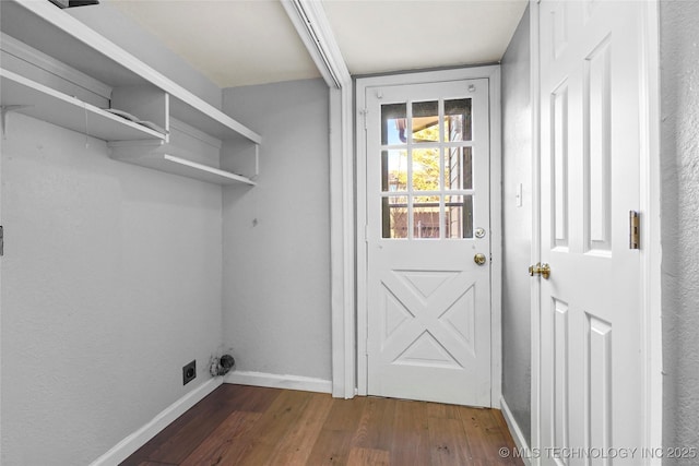 laundry room with electric dryer hookup and dark wood-type flooring